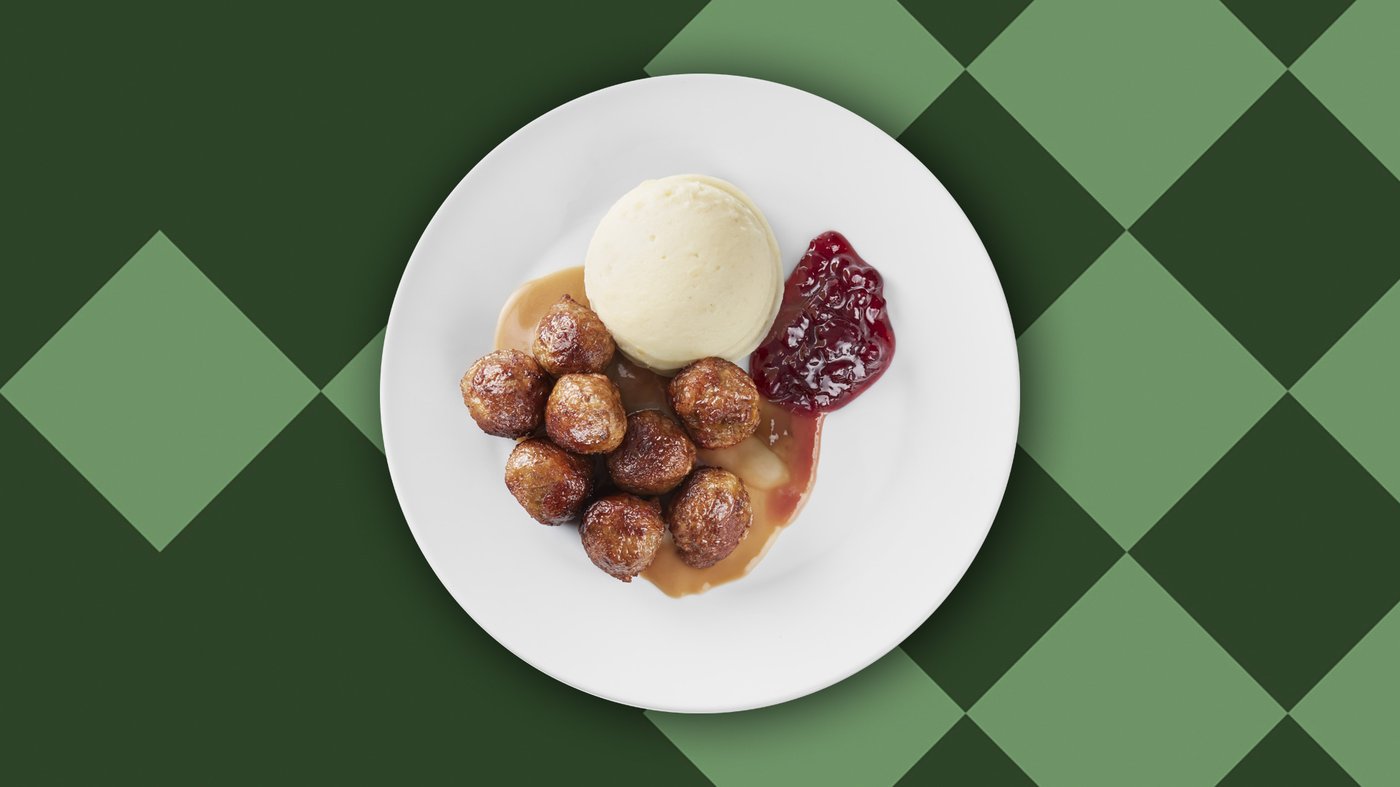 Un piatto di polpette con purè, salsa e marmellata di mirtilli rossi. 