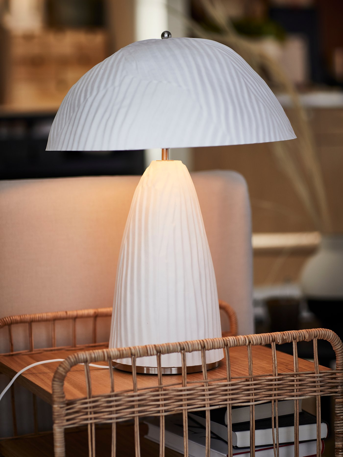 A white table lamp on a side table.