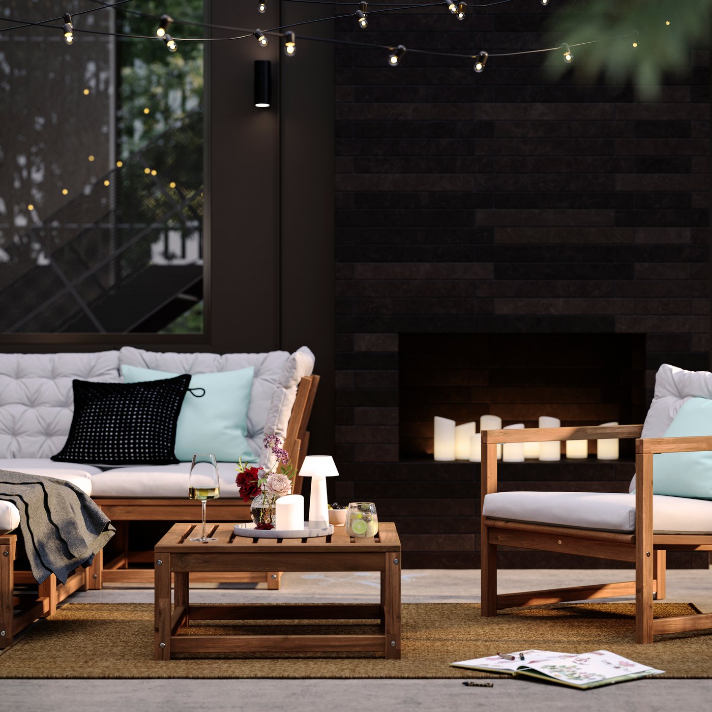 A patio with light brown stained outdoor NÄMMARÖ lounge seating and a seat section for a modular sofa doubling as a table.