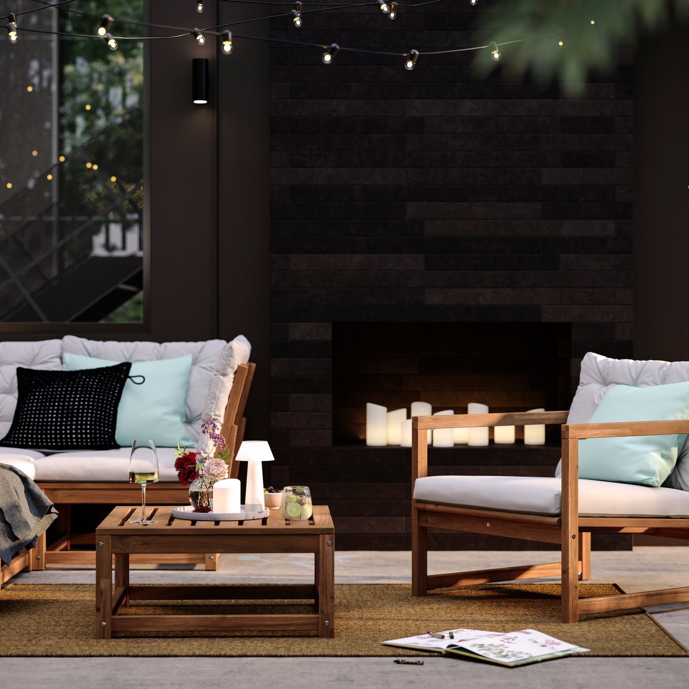 A patio with light brown stained outdoor NÄMMARÖ lounge seating and a seat section for a modular sofa doubling as a table.