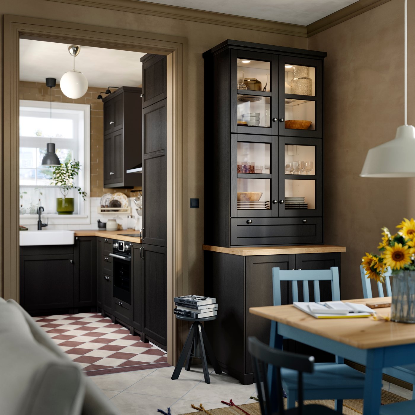A kitchen featuring a black stained LERHYTTAN glass door cabinet holding dishes, beside a table with chairs.