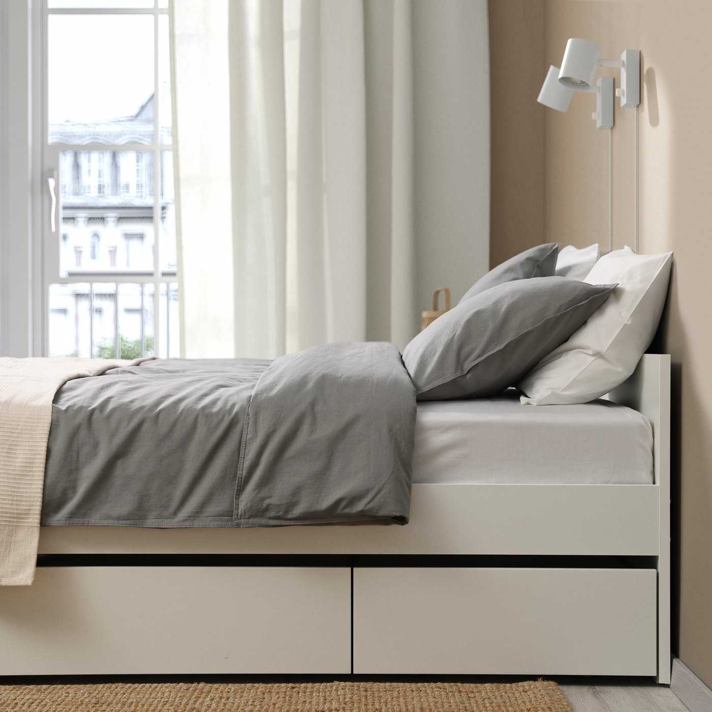 A white/Luröy VIHALS bed frame with 2 storage boxes in the bedroom