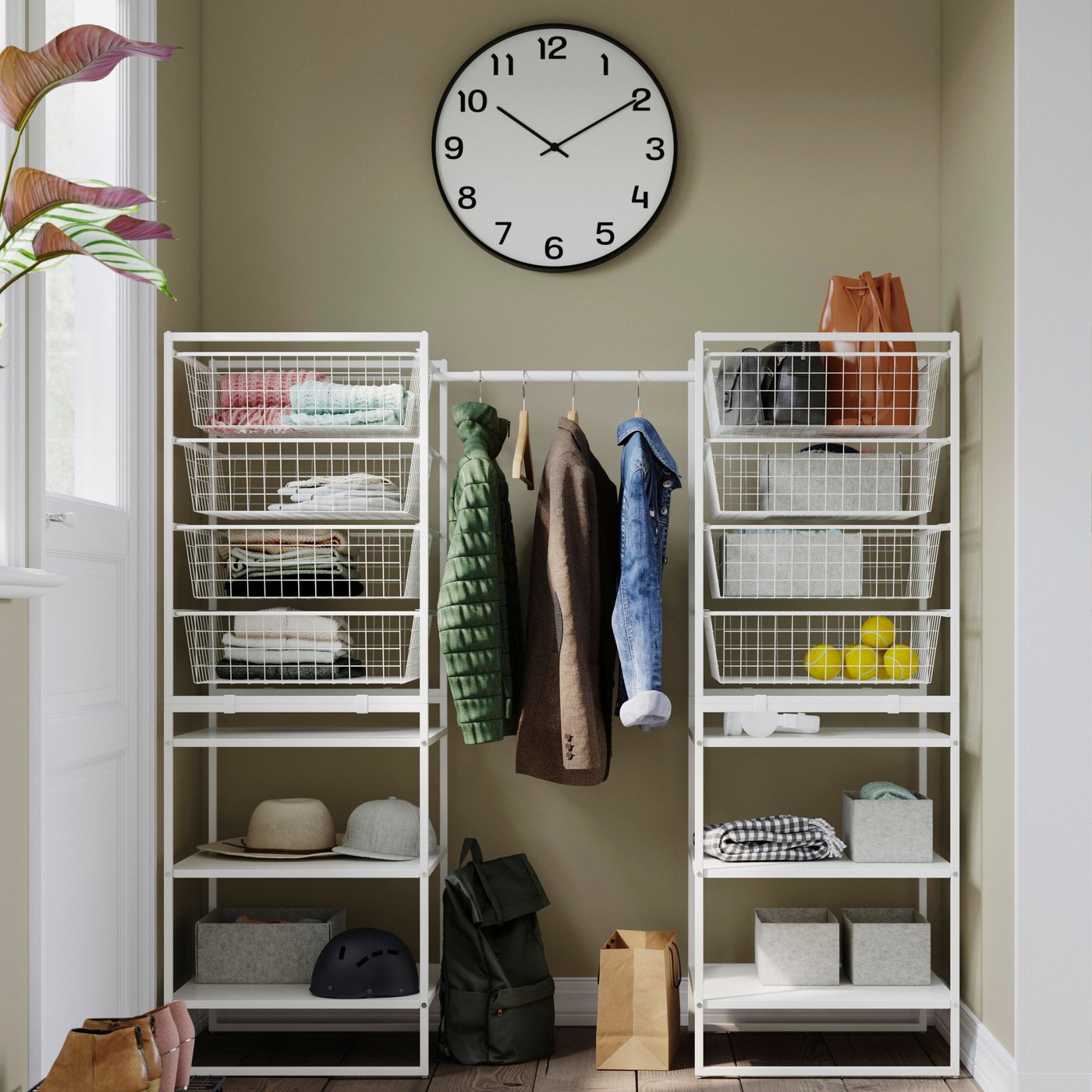 A neatly organised JONAXEL system with jackets hanging from a rail and shelves and drawers organised to perfection.
