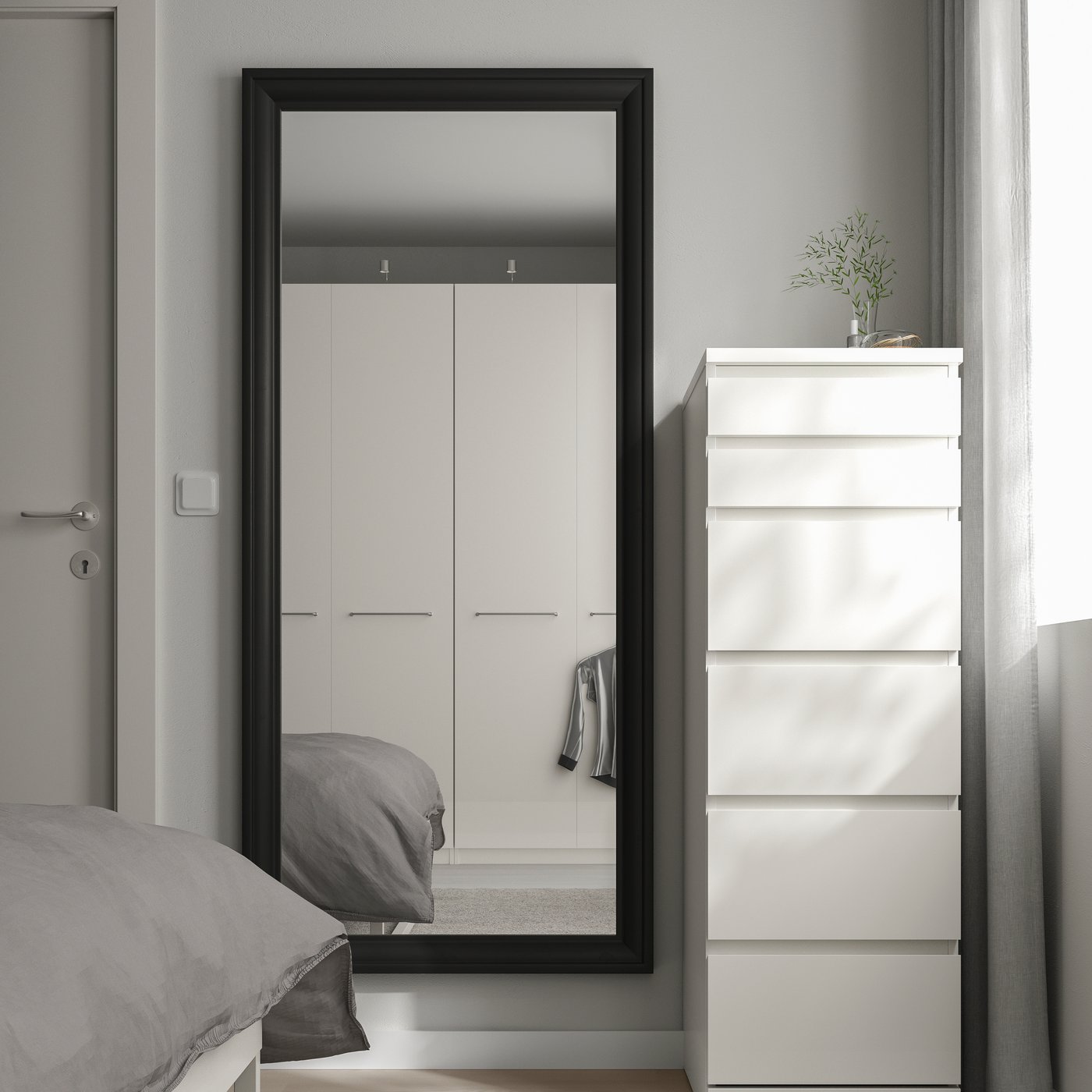 A black TOFTBYN mirror in the bedroom