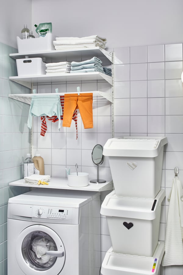 A BOAXEL wardrobe combination with clothes hanging from it, 