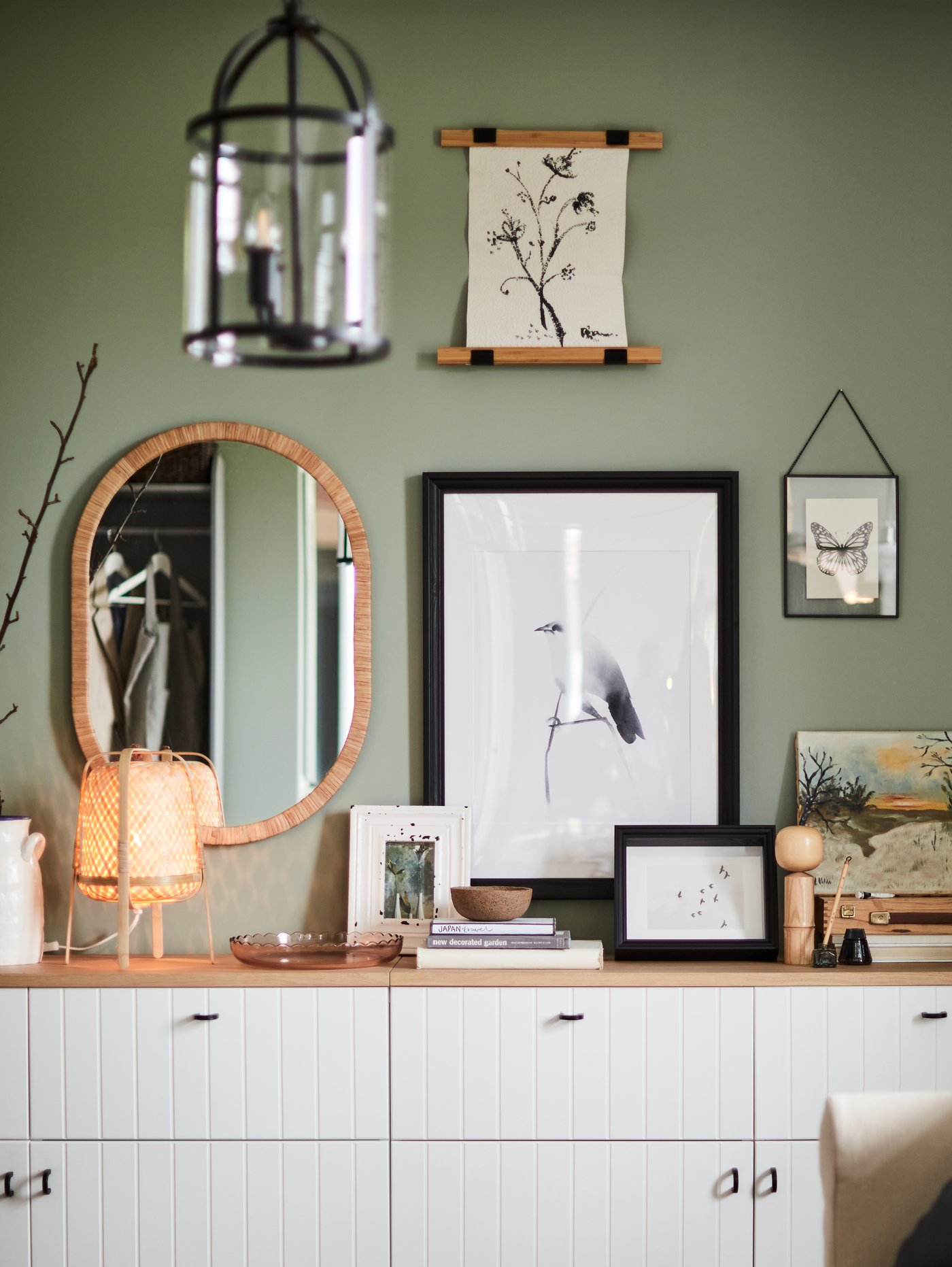 OPPHEM mirror, EDSBRUK frame and other decoration hang on a green wall.