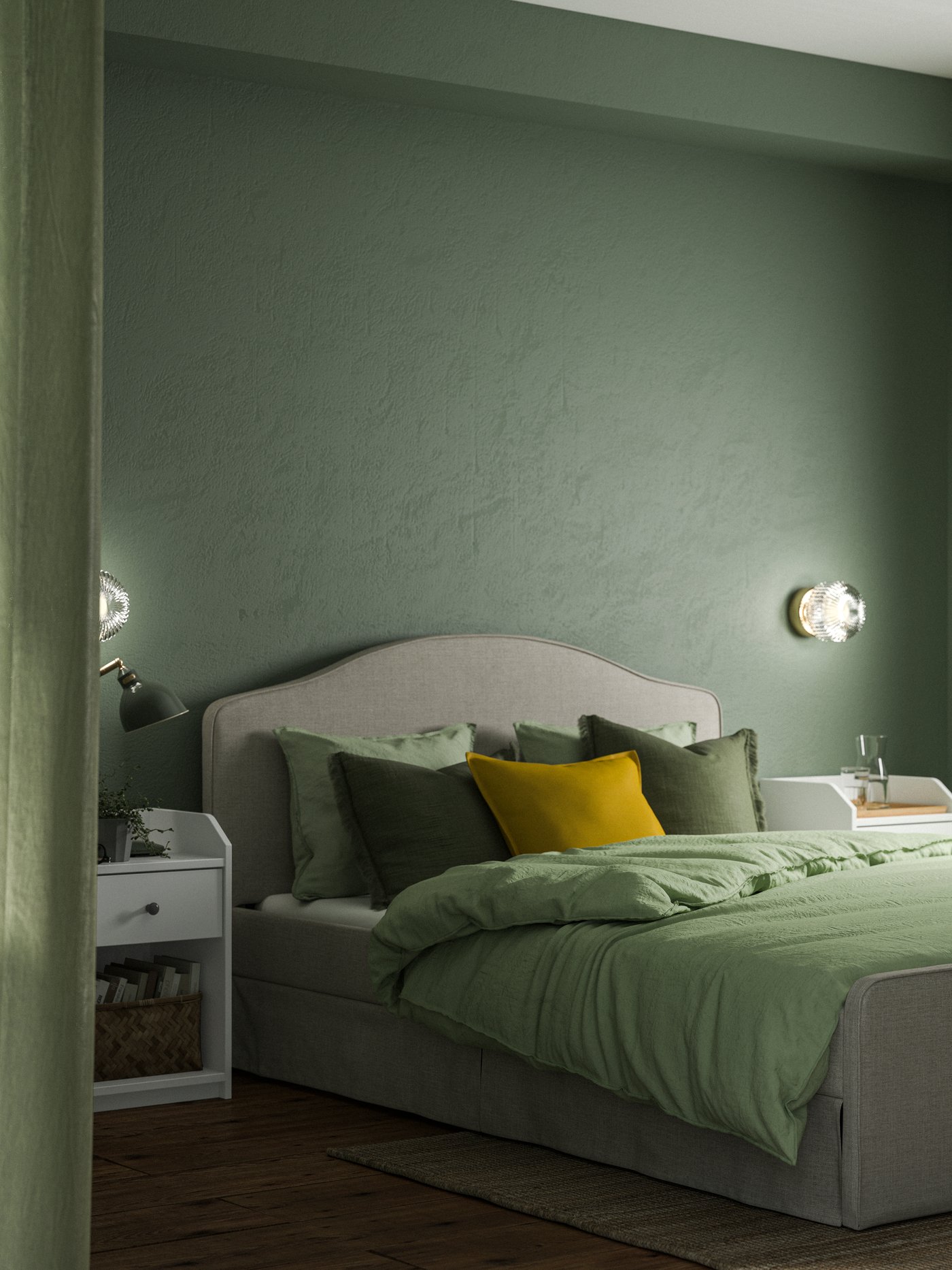 A bedroom with soft green walls and RAMNEFJÄLL upholstered bed with green bedding and lots of cushions.