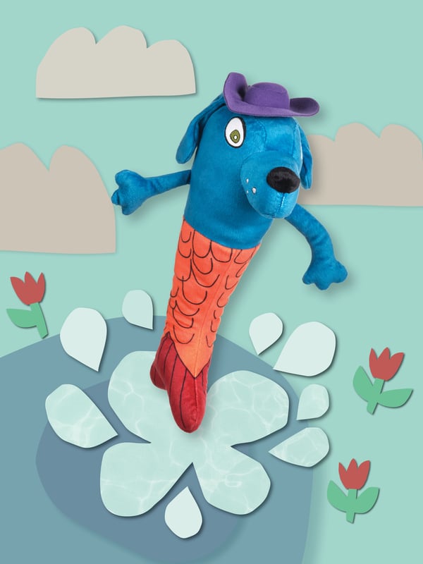 The SAGOSKATT 2021 mermaid-dog soft toy is standing in an illustrated flower bed.