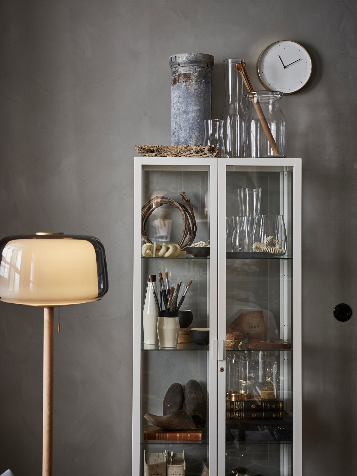 A white MILSBO glass-door cabinet in the living room