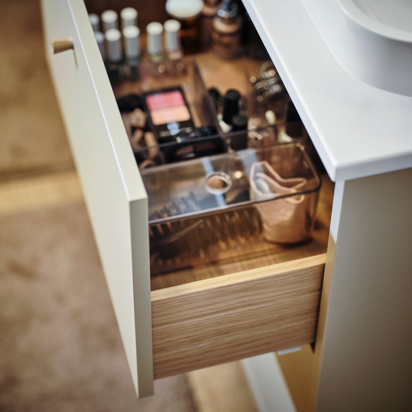 A beige HAVBÄCK wash-stand with drawers in the bathroom
