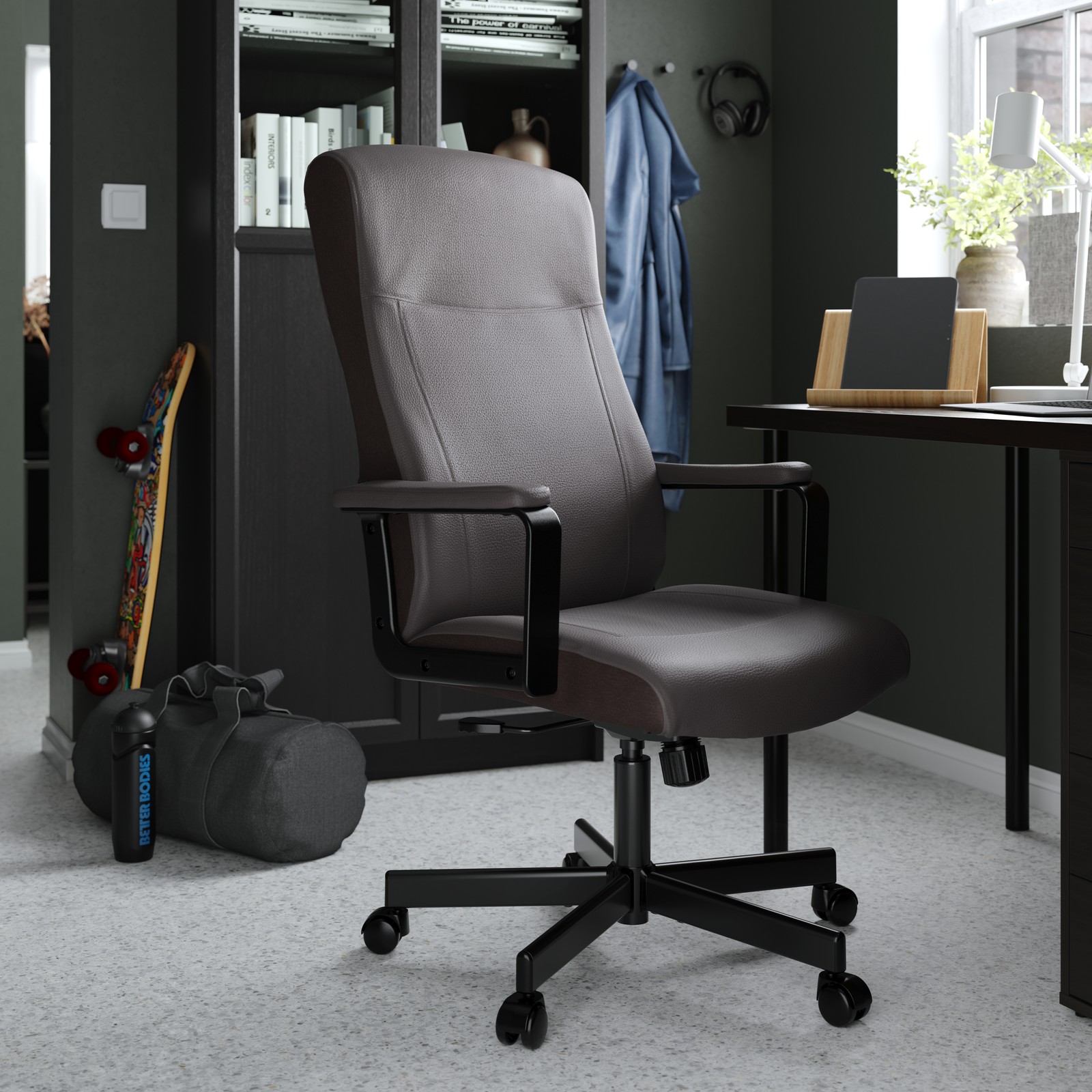 Una silla de oficina MILLBERGET negra frente a un escritorio.