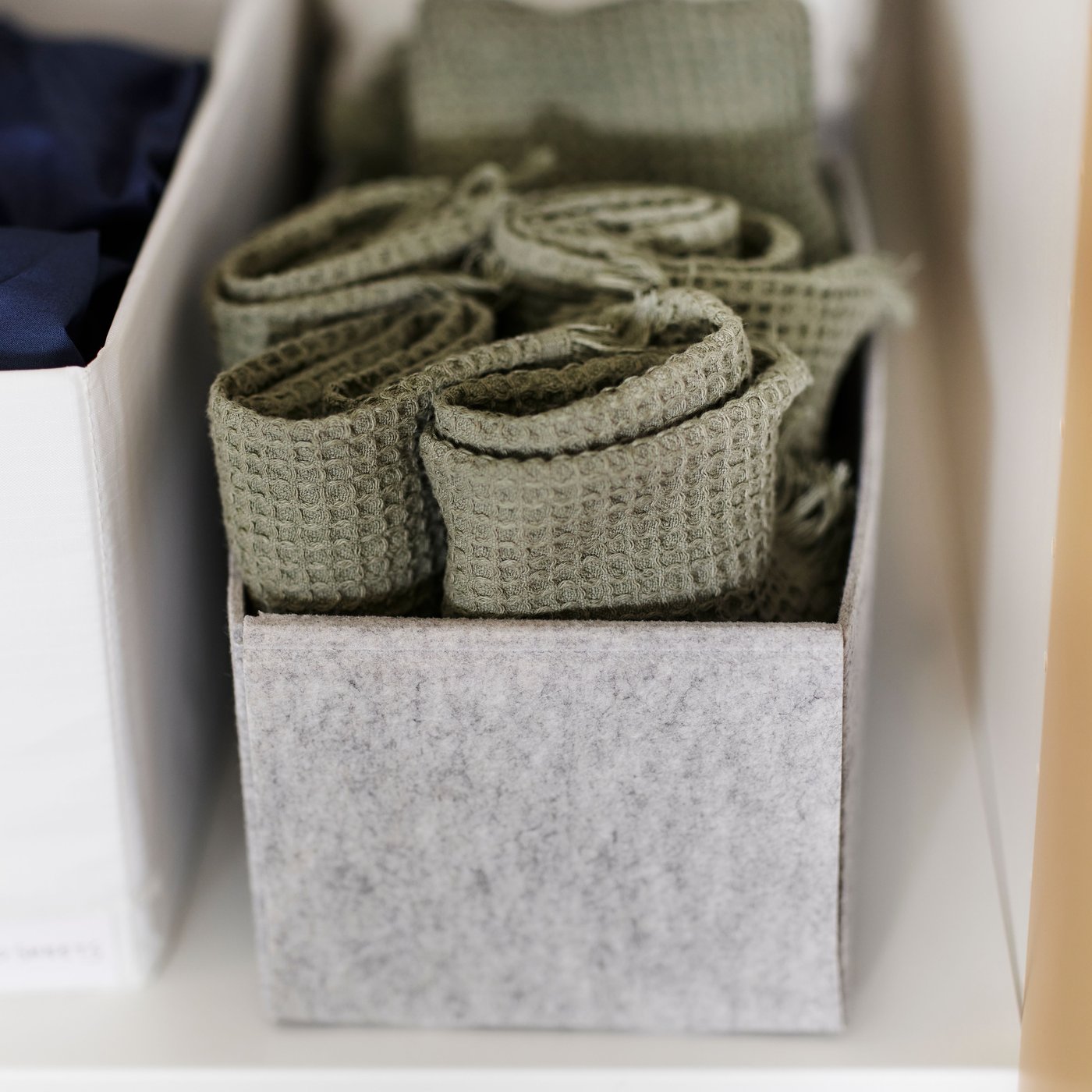 A light green VALLASÅN hand towel in the bedroom