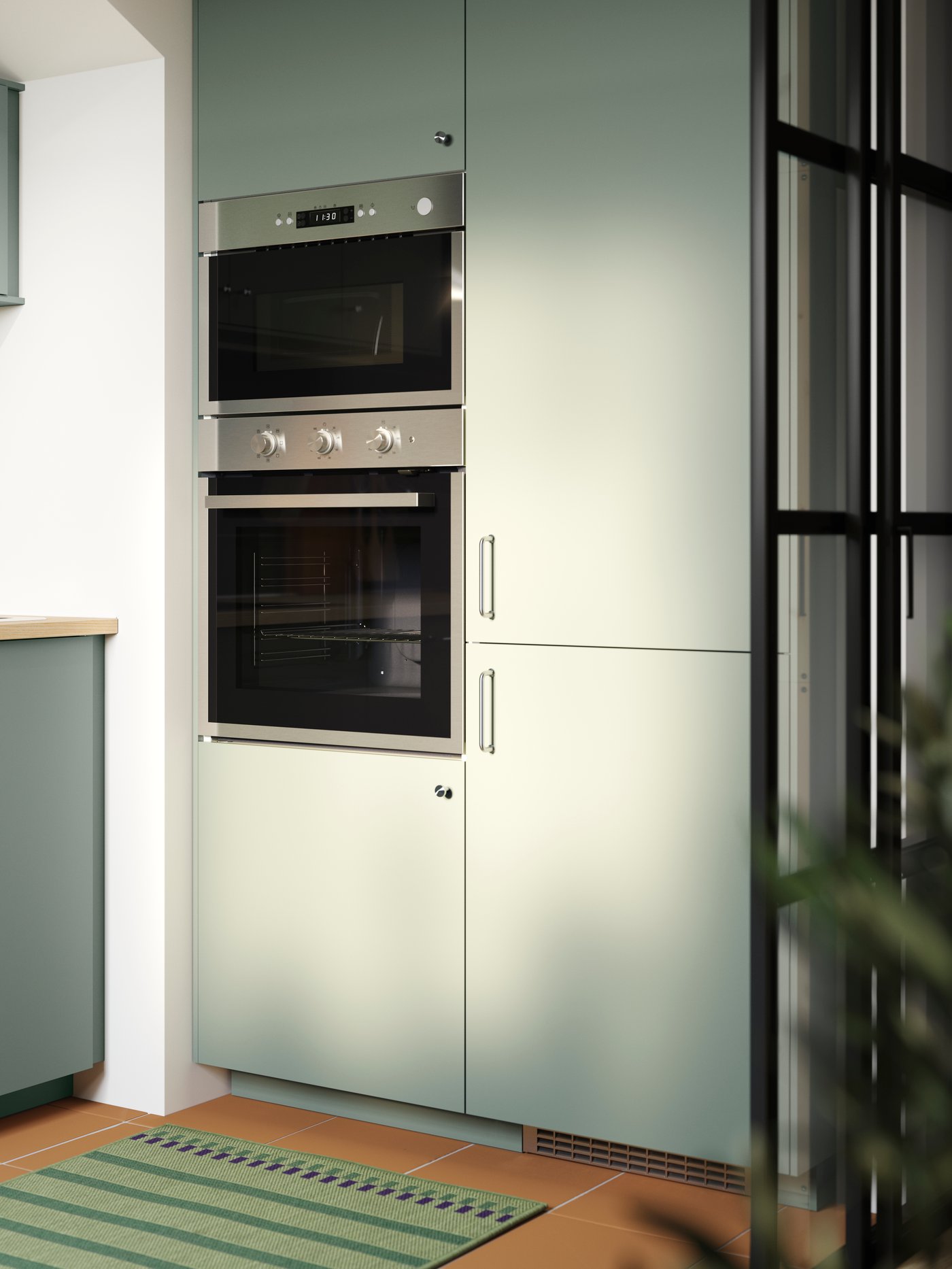 Kitchen with NICKEBO fronts in mat grey-green with integrated fridge-freezer, built-in oven and microwave.