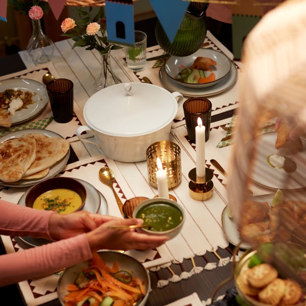 A white GOKVÄLLÅ soup tureen sits on a beautifully decorated table with various dishes, candles, and festive decor.