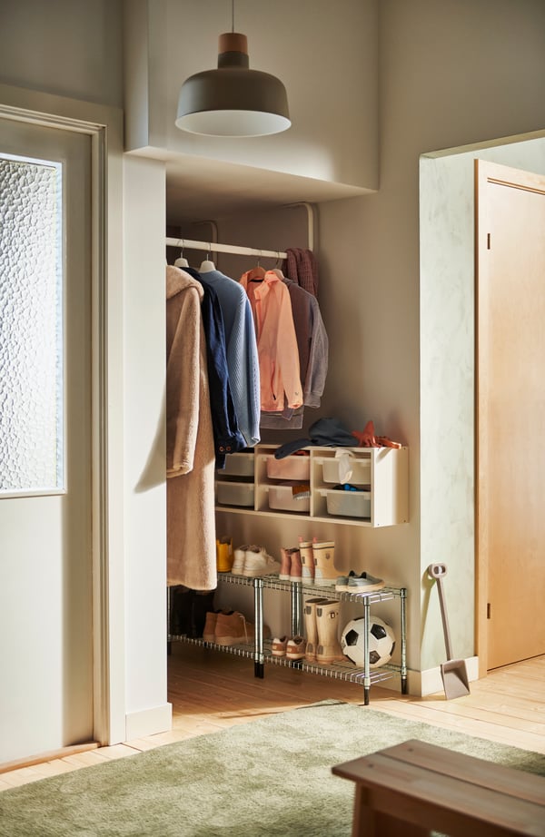 Storage solution in a small hall, including a TROFAST storage module on the wall.