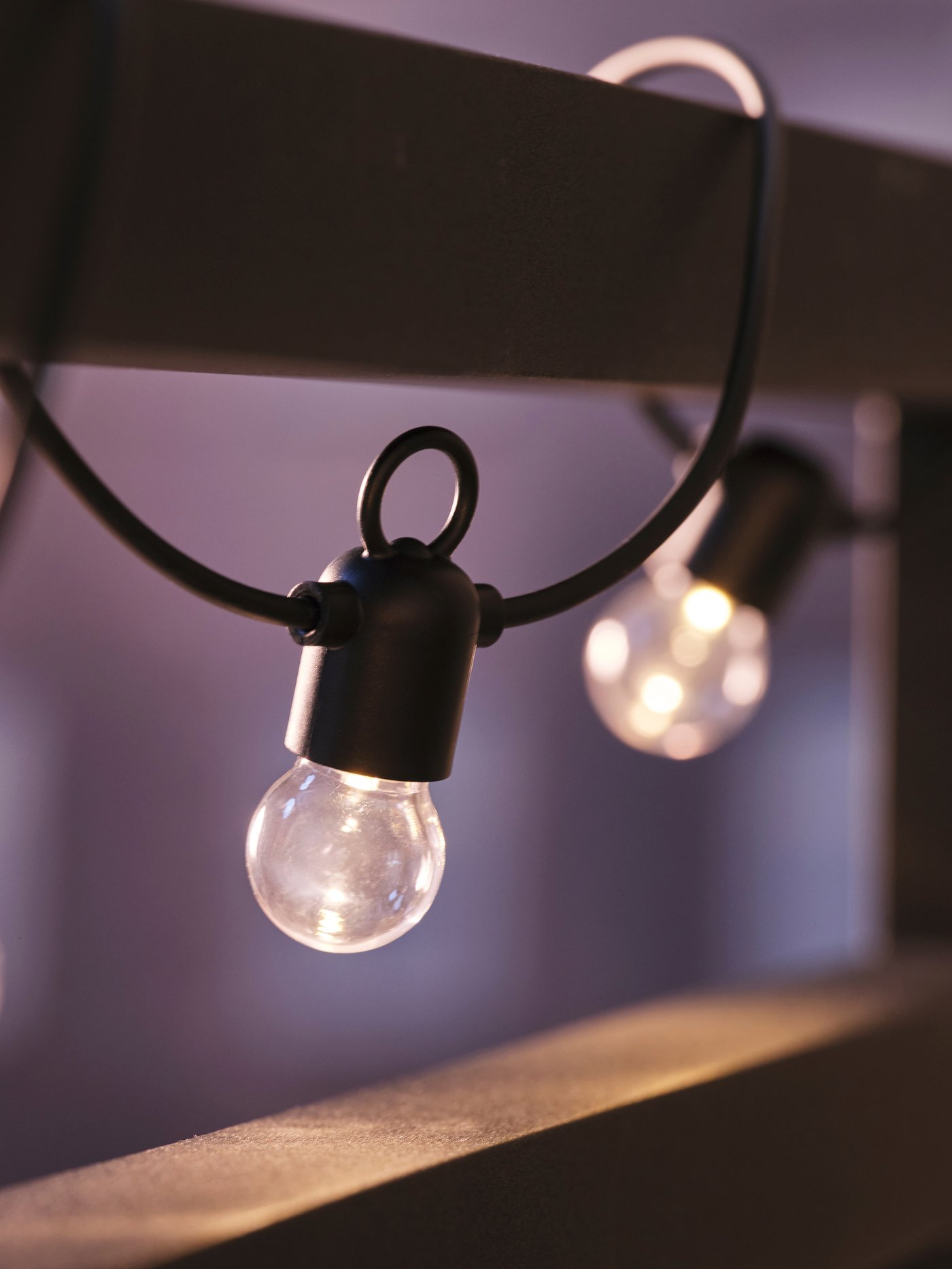 An outdoor black UTSUND LED lighting chain with 24 bulbs