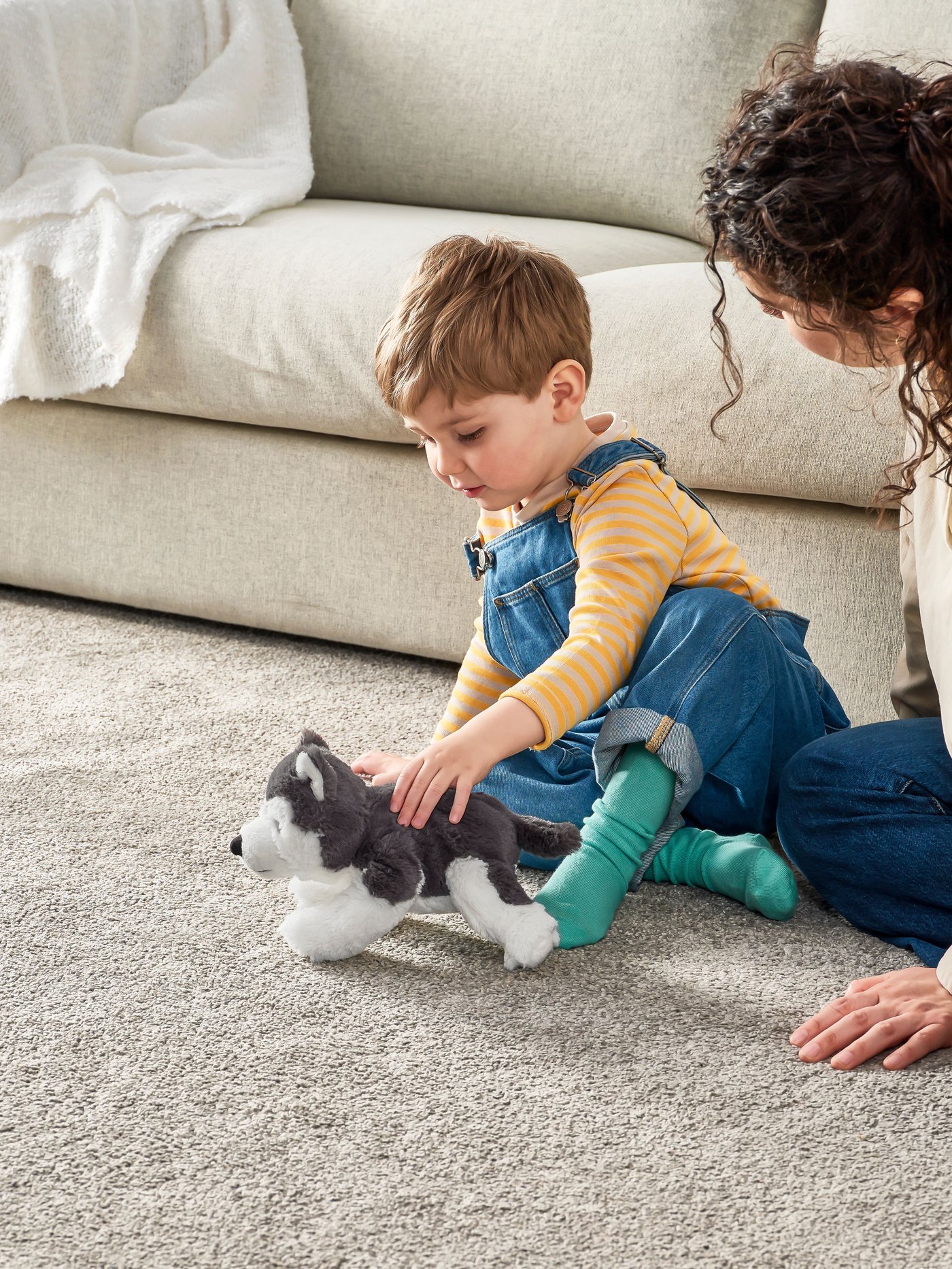 A dog/siberian husky LIVLIG soft toy in the living room