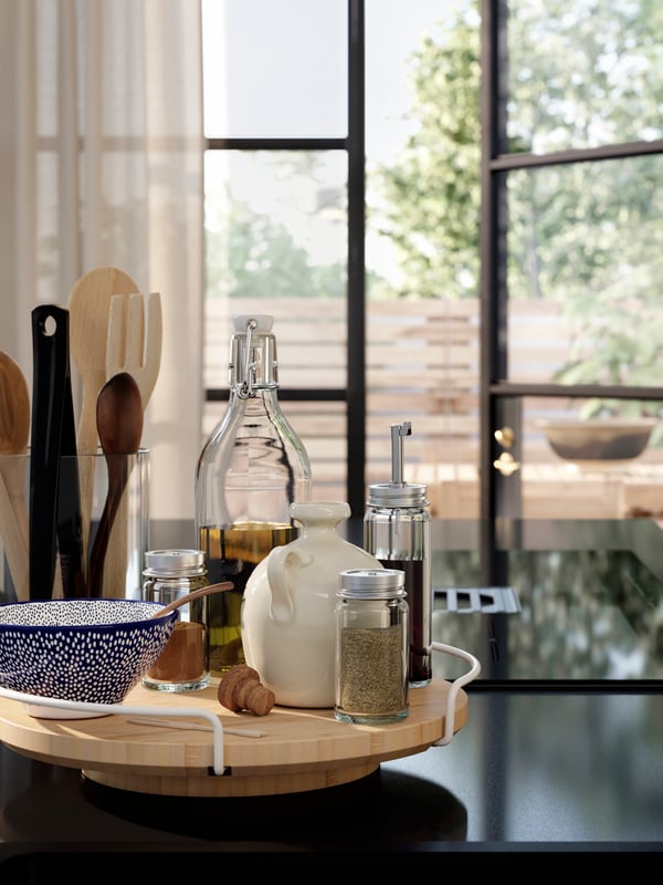 APTITLIG lazy susan on a kitchen counter, neatly displaying kitchen essentials such as spices, oil bottles, and utensils.
