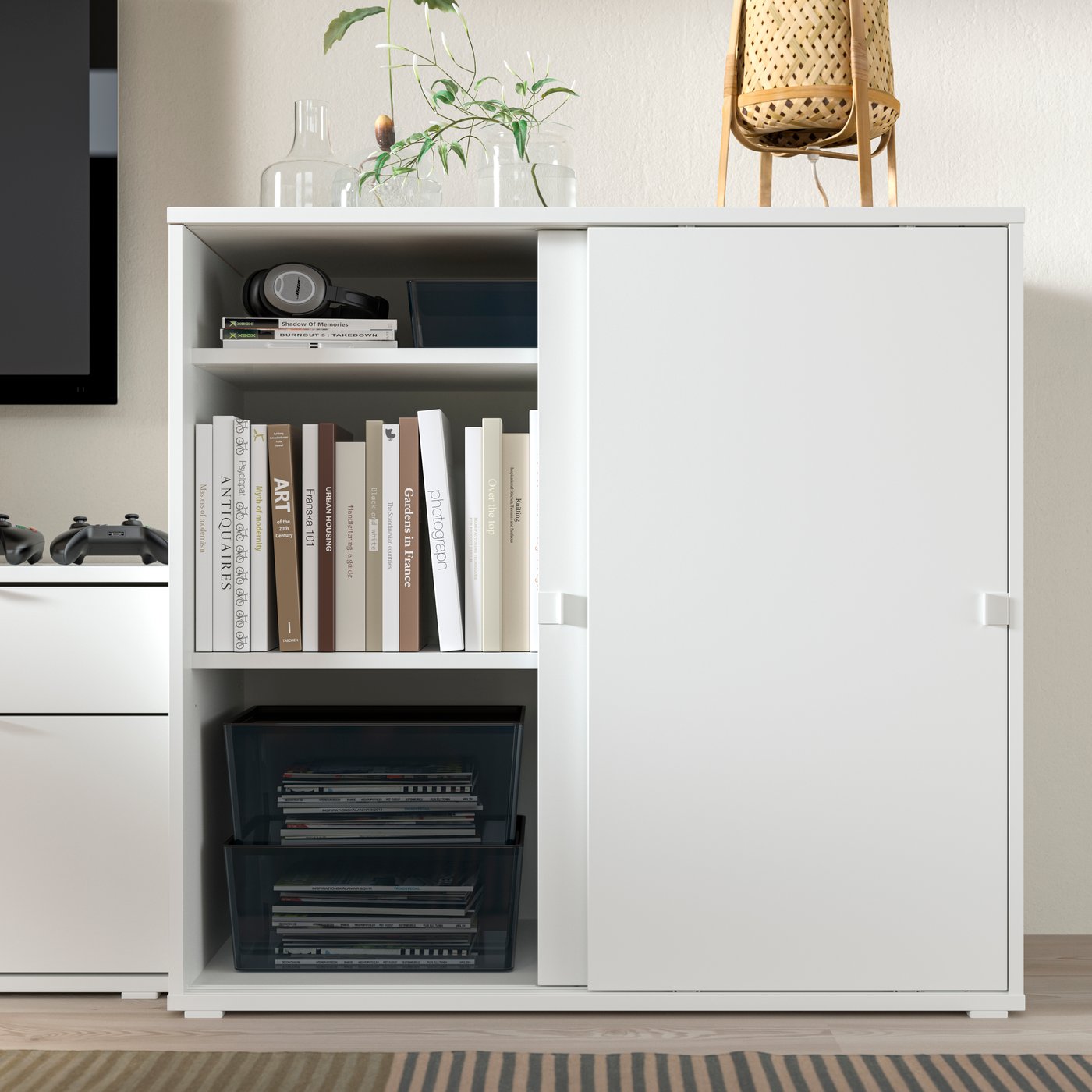 A white VIHALS cabinet with sliding doors in the living room