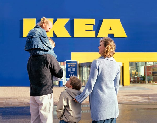 Family walking towards IKEA store entrance. 