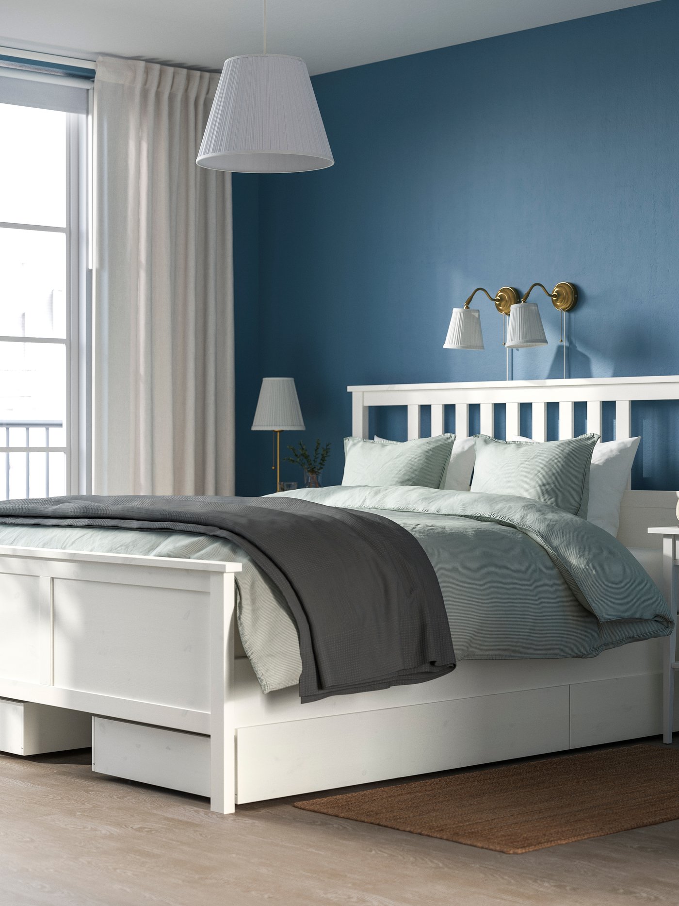 A white stain HEMNES bed frame with 4 storage boxes in the bedroom