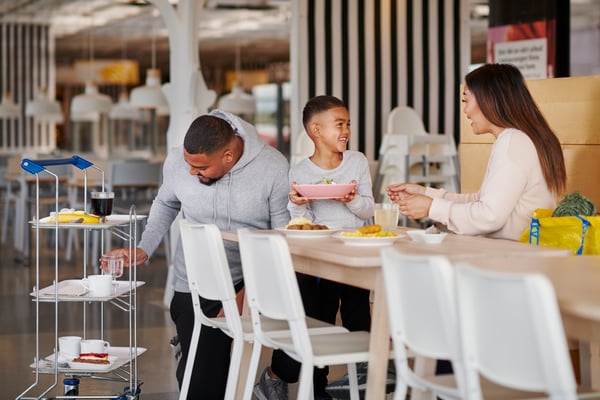 Family eating meatballs and potato puree at IKEA.