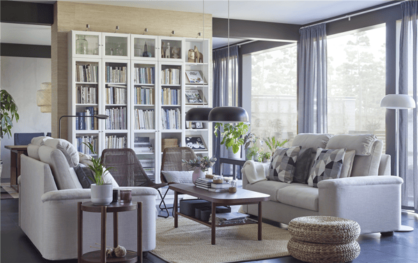 A LIDHULT white couch and a BILLY open cabinet in a fully furnished livingroom