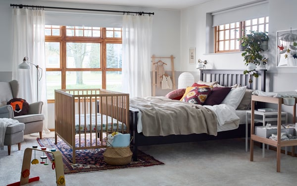 A Skiftebo light beige STRANDMON wing chair in the bedroom