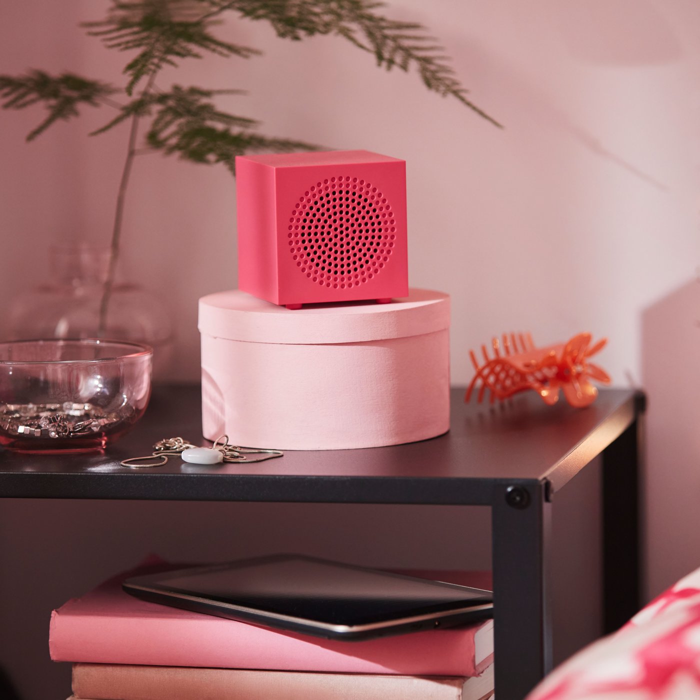 A pink KALLSUP portable Bluetooth speaker.