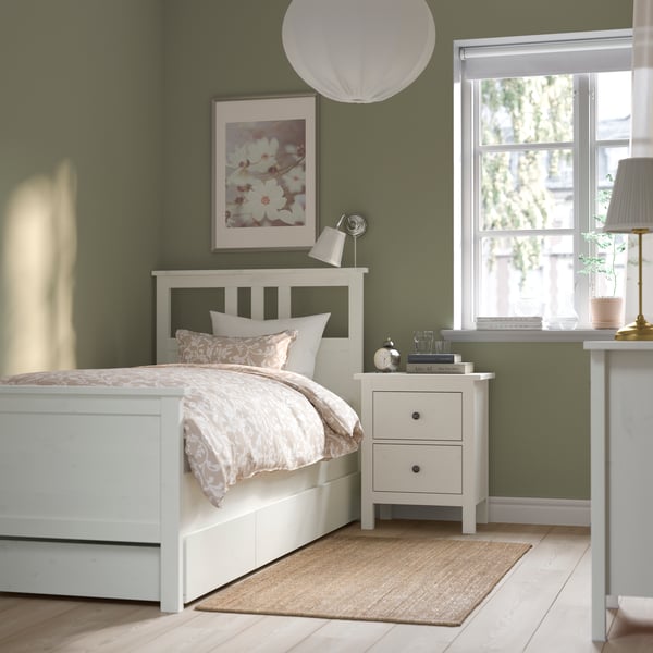 A white stain HEMNES bed frame with 2 storage boxes in the bedroom