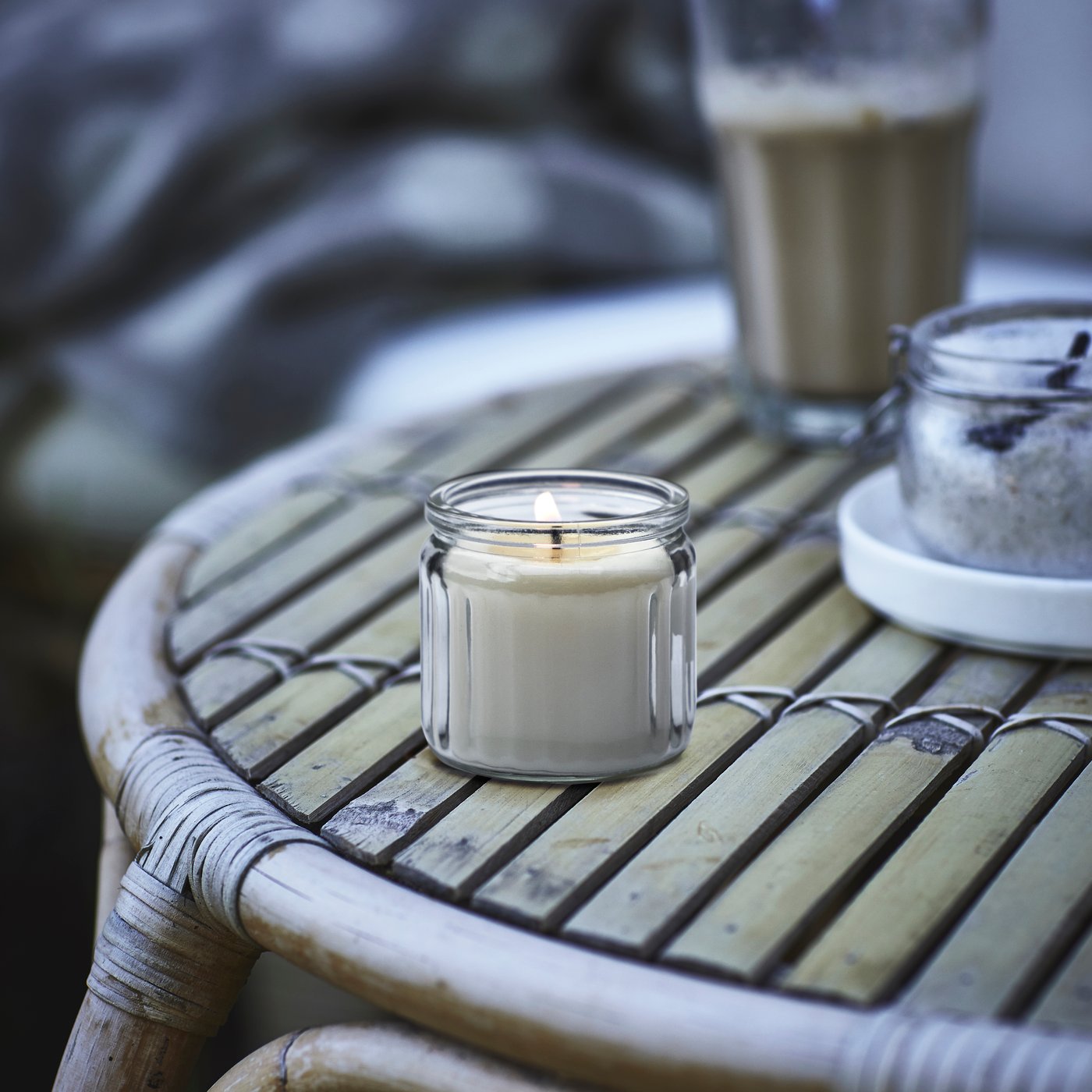 A Vanilla/light beige JÄMLIK scented candle in glass