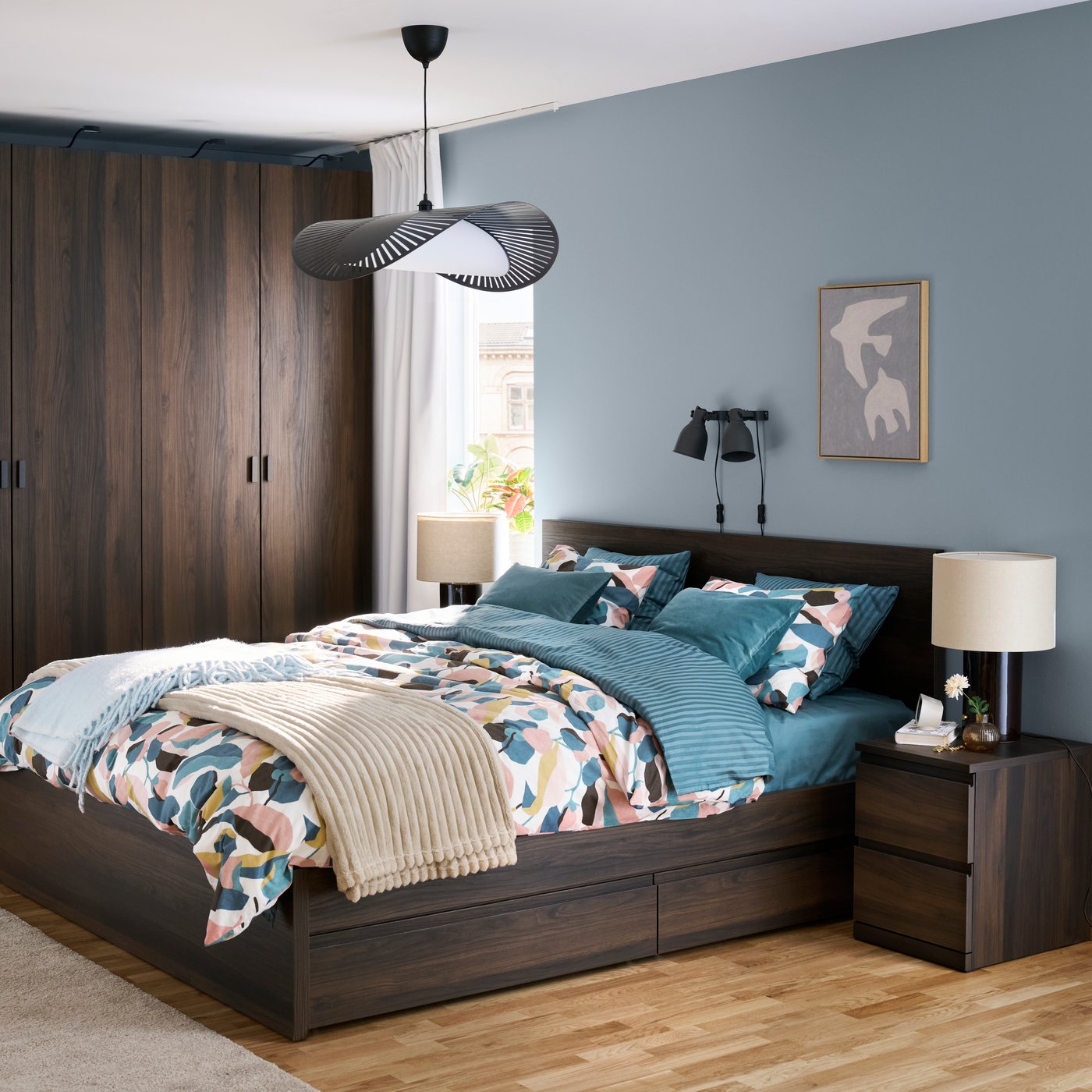 A black KVÄLLSDOPP pendant lampshade in the bedroom