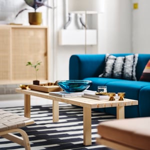 An off-white/black STOCKHOLM 2025 cushion cover in the living room