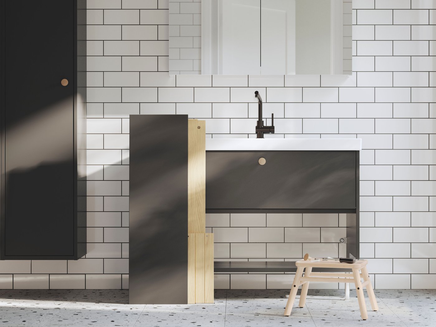 New washstands with washbasins are being installed in a bathroom. There’s part of a drawer on the floor and tools on a stool.