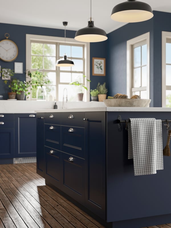 A matt blue AXSTAD cover panel in the kitchen