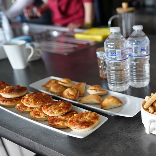 An image of cookies and bottles of water on a table in the kitchen. 