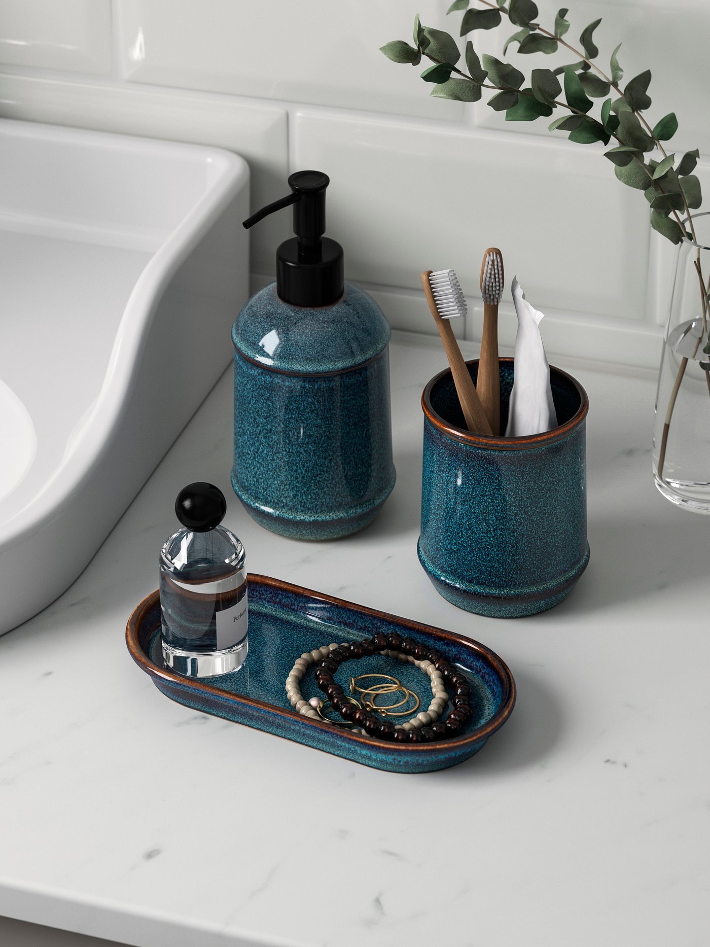 A blue 3-piece TVÅLSJÖN bathroom set on a white worktop.