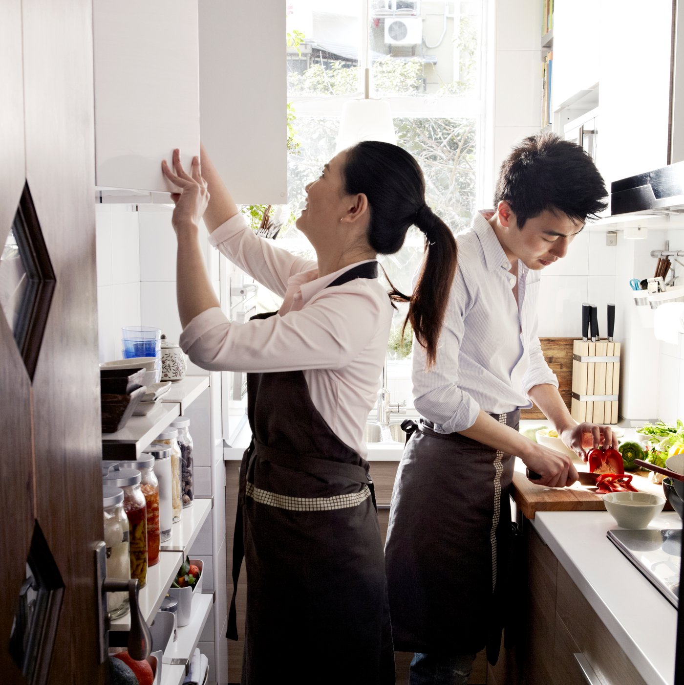 Two people cooking together.