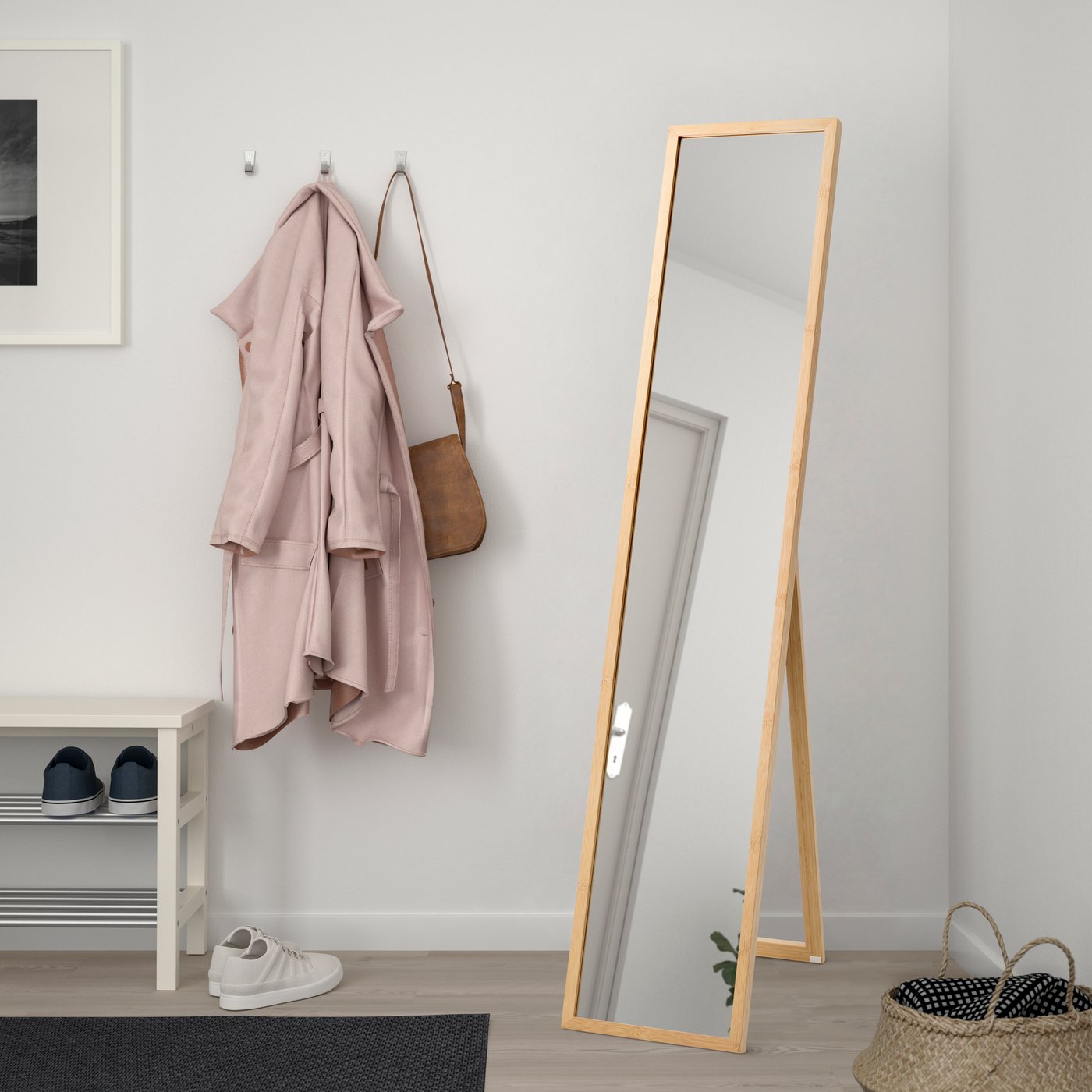 A bamboo VÄRSNÄS standing mirror