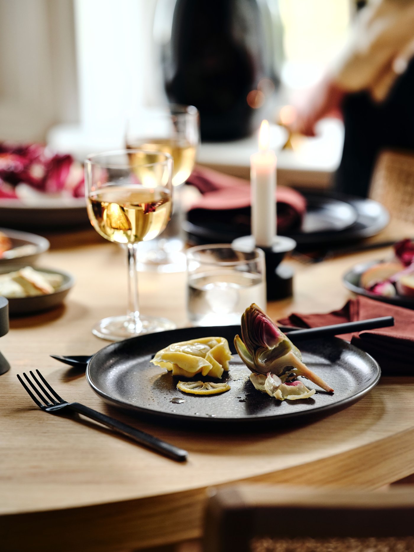 A white JUBLA unscented chandelier candle