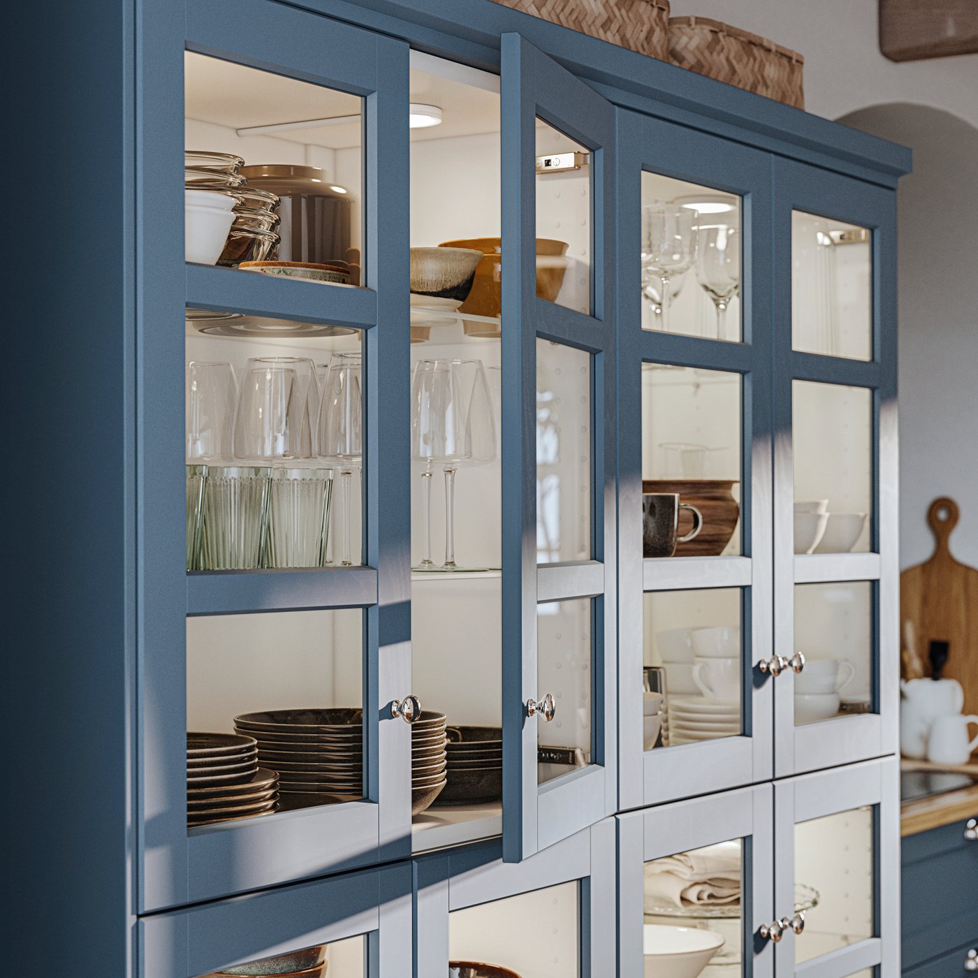 A dining room cabinet with glass doors in LERHYTTAN blue displays dining room items on shelves inside.