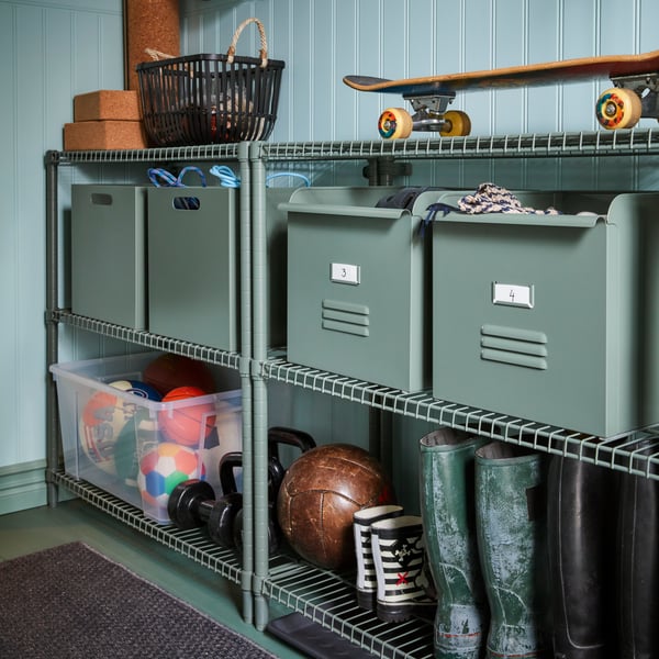 IKEA OMAR shelving unit with REJSA and SAMLA containers holding outdoor and sport gear in the shed or garage.