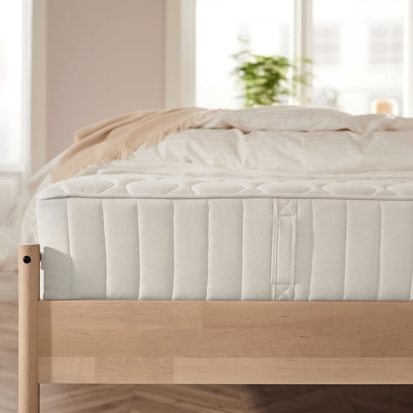 A firm/white VÅGSTRANDA pocket sprung mattress