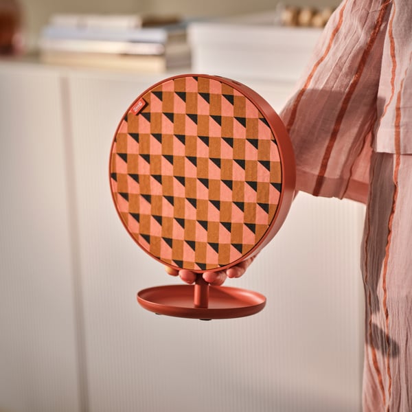 An orange SOLSKYDD portable Bluetooth speaker