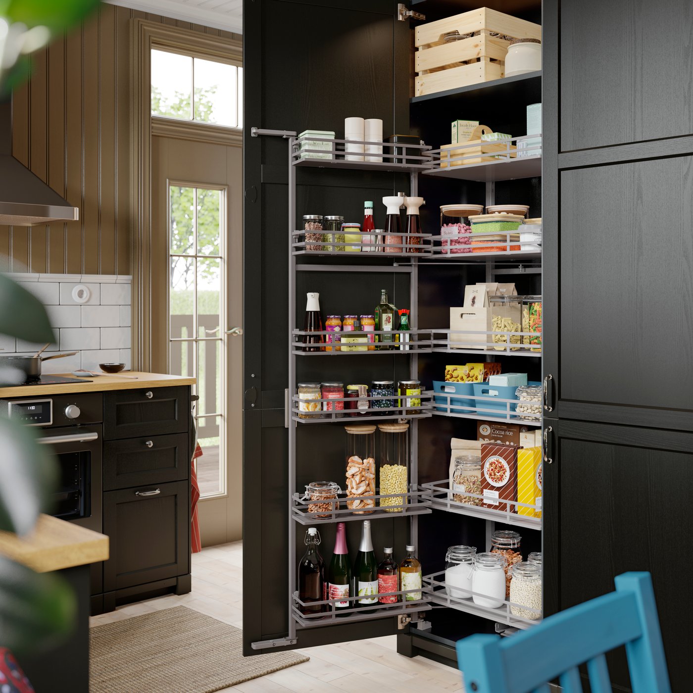 A kitchen with a METOD high cabinet as a pantry with a pull-out larder filled with jars and condiments near the countertop
