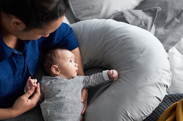 A grey LEN nursing pillow