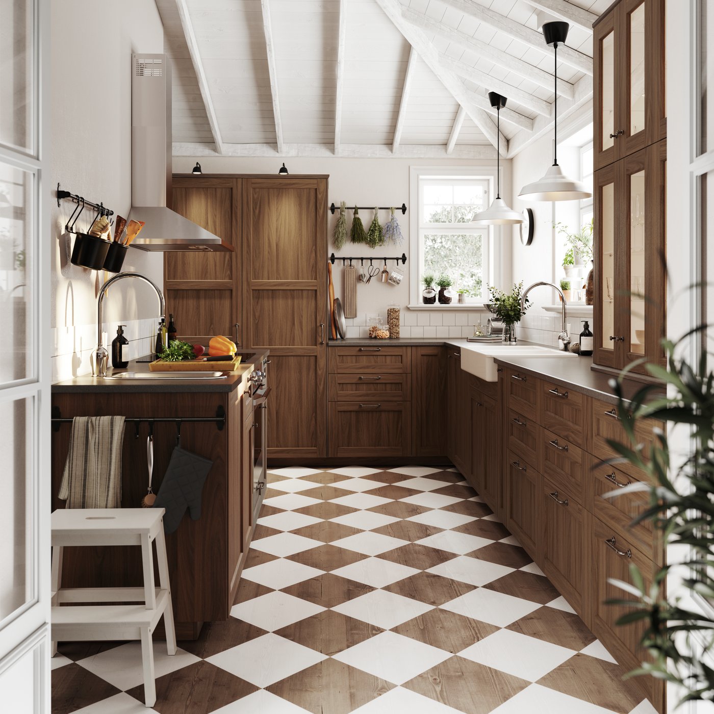 A traditional kitchen with a brown and white checkered floor, wooden cabinets, a light-coloured worktop, and a silver extractor hood.