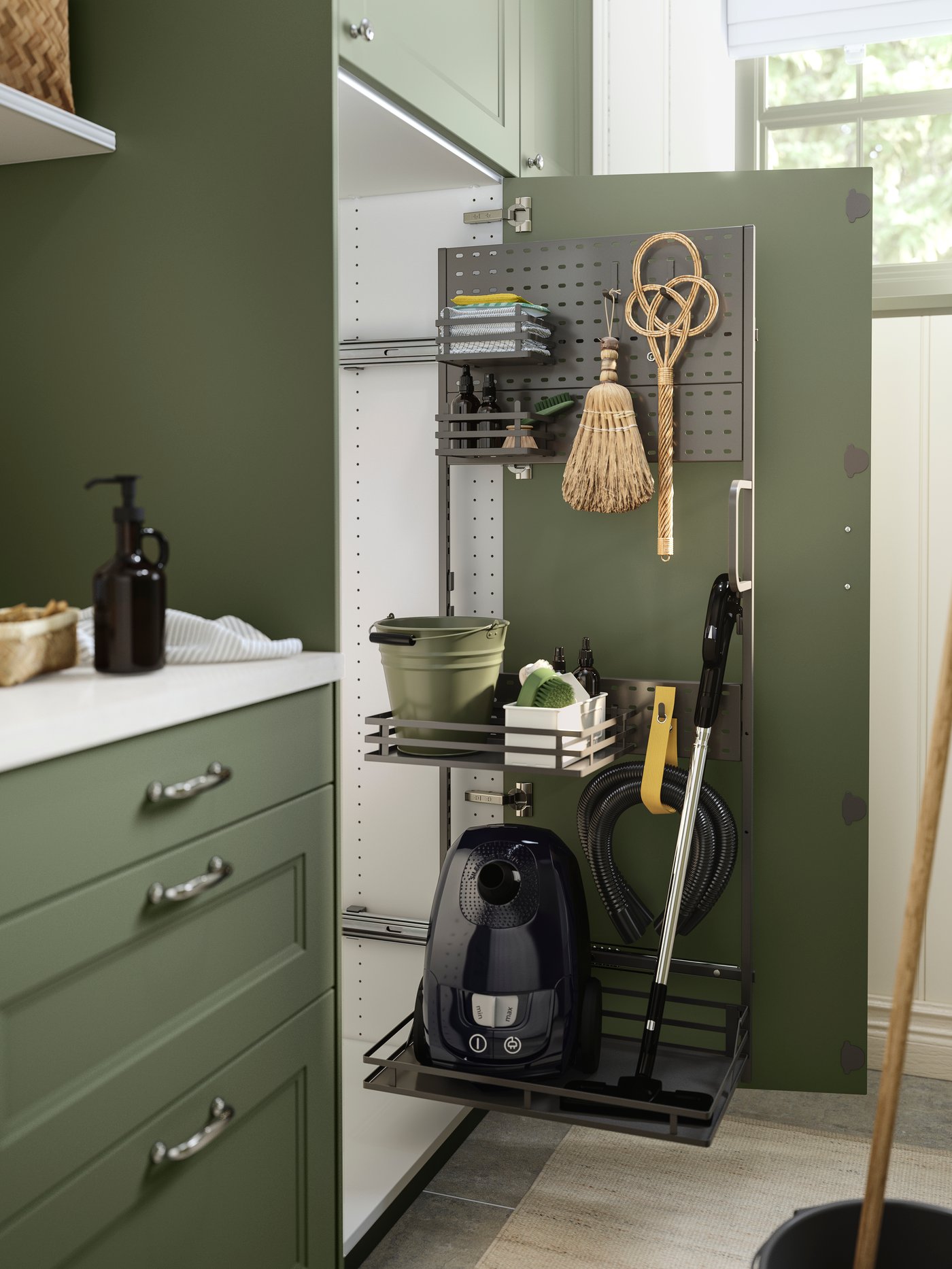 A cabinet door is open and there is an UTRUSTA cleaning interior on the inside of the door with organised cleanings utensils.
