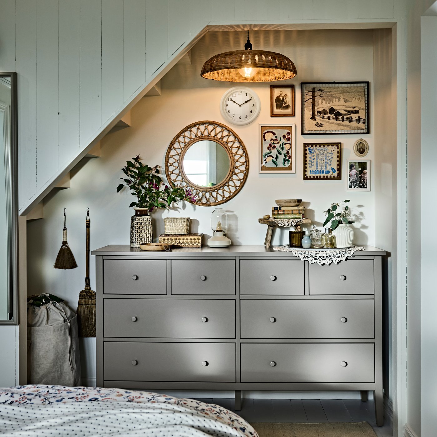 A sloped-ceiling bedroom area featuring a GULLABERG chest of 8 drawers with plants and decor arranged on top.