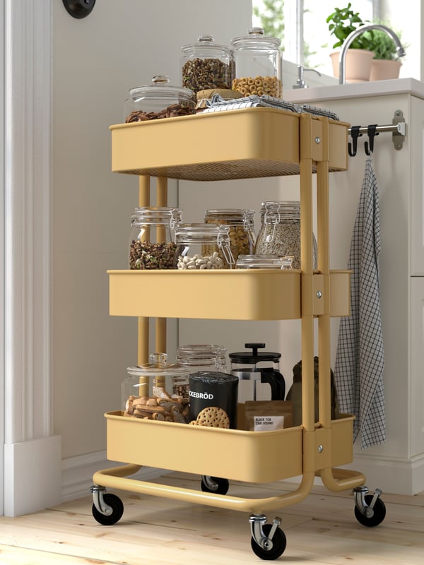 A beige-yellow RÅSKOG trolley